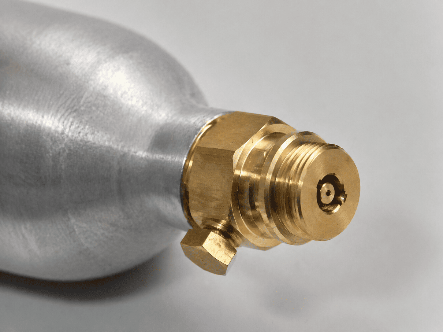 A close-up of a CO2 cylinder valve for a soda maker